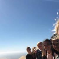 Students sitting on a dune slope